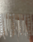 Completo in tweed con frange di perle