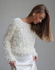 Blusa texturizada con detalles de plumas