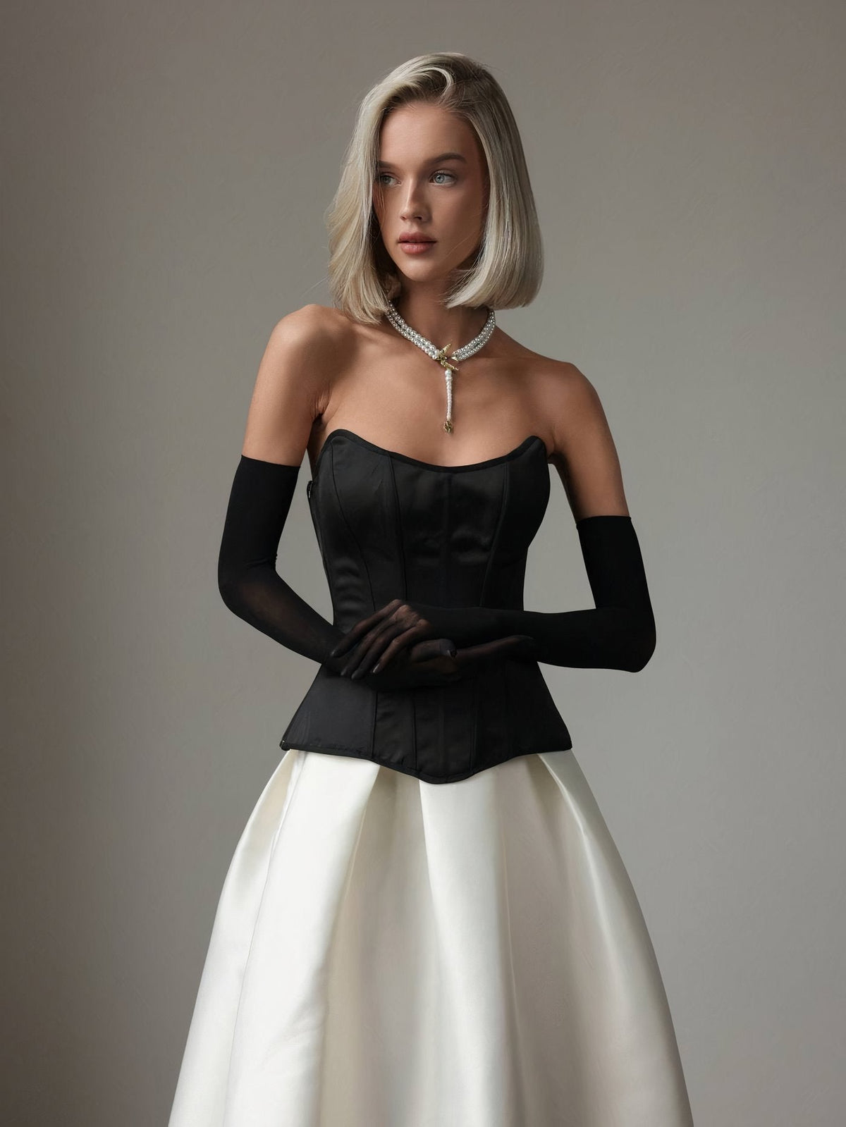 Black corset, pearls and satin skirt